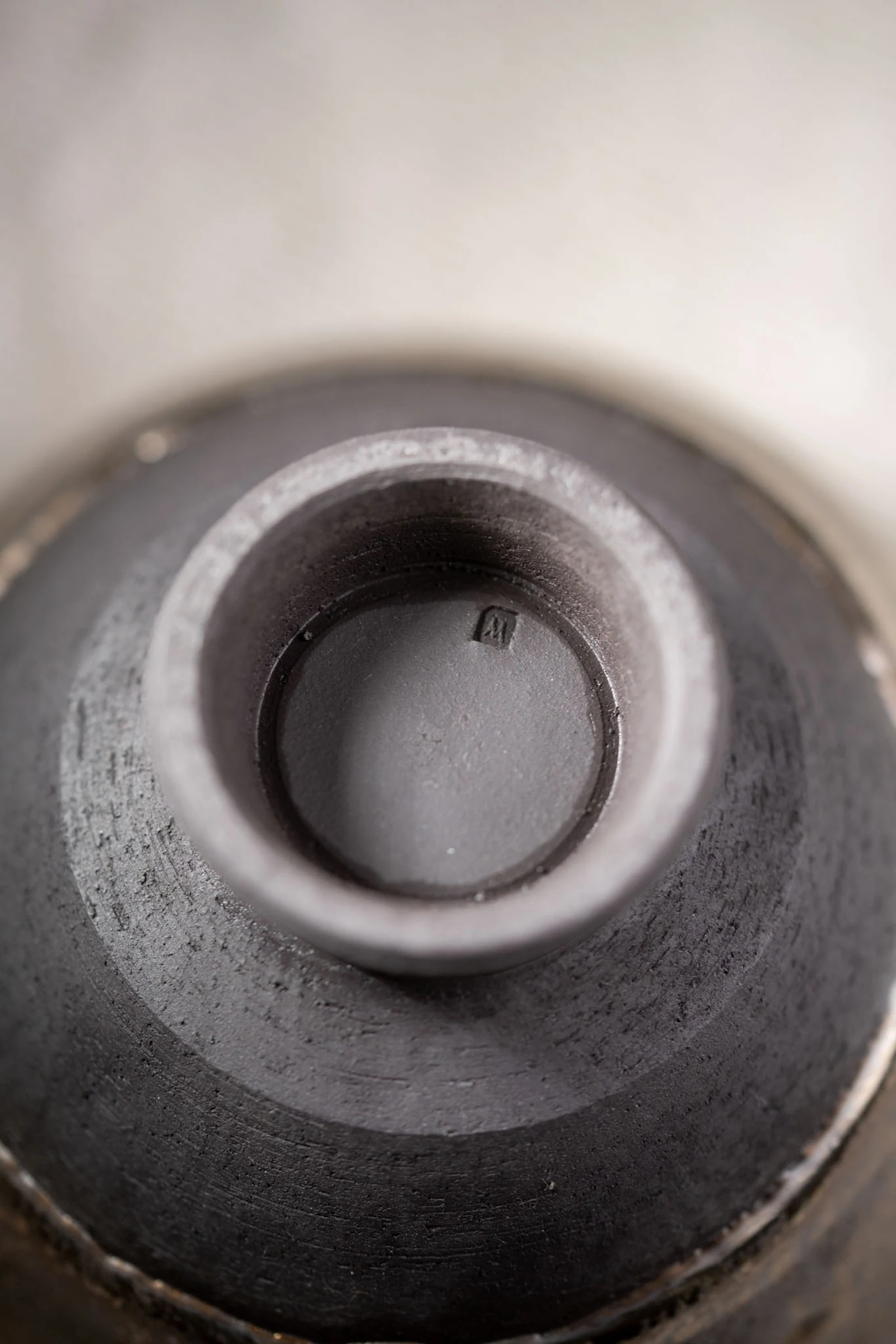 Looking down the axis of a handmade cup, wheel rings visible